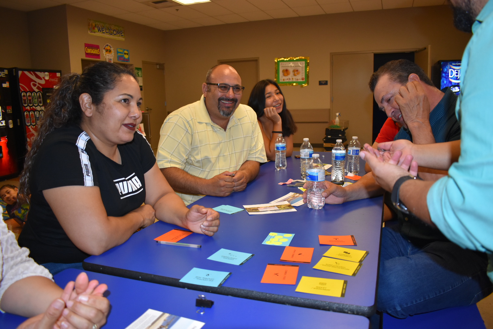 People gathered around a table smiling.